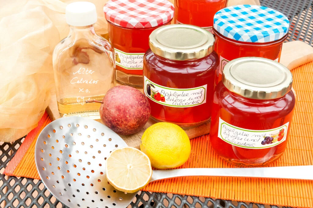 screw-top with spiced apple jelly,label and skimmers are on a table